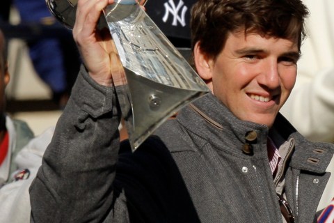 New York Giants quarterback Eli Manning holds up the Vince Lombardi Trophy as he attends a ceremony in honor of the Giants' win in the NFL Super Bowl XLVI, at City Hall Plaza in New York