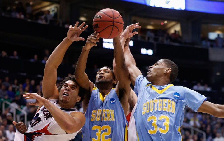 Gonzaga forward Harris battles for a loose ball with Southern University center Moore and guard Miller during the second half of their second round NCAA tournament basketball game in Salt Lake City, Utah