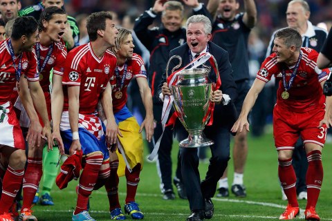 Bayern Munich coach Jupp Heynckes celebrates with the trophy and his players after defeating Borussia Dortmund in their Champions League Final soccer match at Wembley Stadium in London