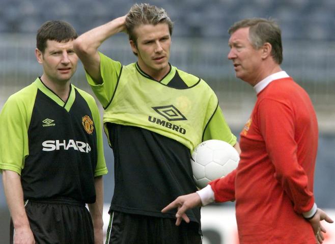 From right: Manchester United's manager Alex Ferguson talks to midfielder David Beckham and defender Denis Irwin at the Camp Nou Stadium in Barcelona, on the eve of the Soccer Champions' League final between the English champion Manchester United and the German champion Bayern Munich, on May, 25 1999.