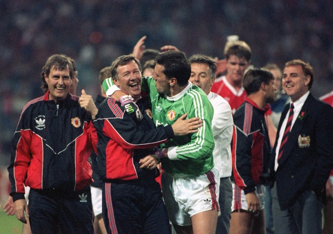 Manchester United manager Alex Ferguson hugs his goalkeeper Les Sealey as they celebrate their FA Cup win against Crystal Palace after a replay, at Wembley Stadium, London, on May 17, 1990.