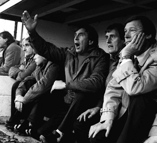 From right: Manchester United manager Alex Ferguson watches his new team for the first time as they crash to a 2-0 defeat, on August 11, 1986.