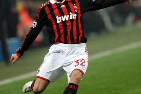 AC Milan's English midfielder David Beckham takes a free kick against Manchester United during their UEFA Champions League round of 16 match at San Siro stadium in Milan, on Feb. 16, 2010.