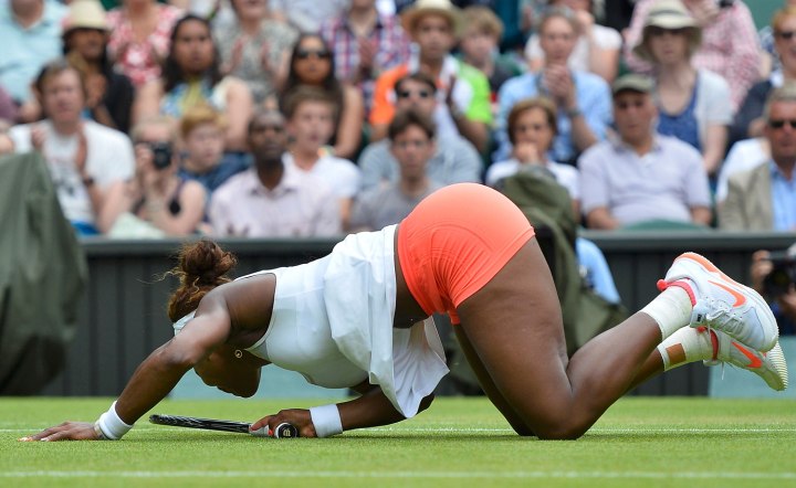Serena Williams of the U.S. falls after diving for a shot during her women's singles tennis match against Sabine Lisicki of Germany at the Wimbledon Tennis Championships, in London