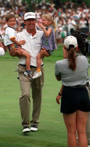 Steve Jones beams as he carries his children, Cy Edmond and Stacey Jane, off the 18th green towards his wife, Bonnie, after winning the US Ope at the Oakland Hills Country Club in Bloomfield Hills, Mich., June 16, 1996. 