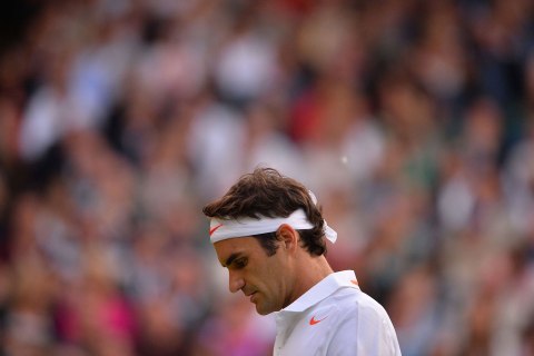 Switzerland's Roger Federer reacts after a point against Ukraine's Sergiy Stakhovsky during their second round men's singles match on day three of the 2013 Wimbledon Championships tennis tournament at the All England Club in Wimbledon, southwest London, June 26, 2013. 