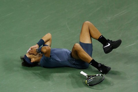 Rafael Nadal, of Spain, falls to the court after defeating Novak Djokovic, of Serbia, during the men's singles final of the 2013 U.S. Open tennis tournament, Sept. 9, 2013, in New York. 