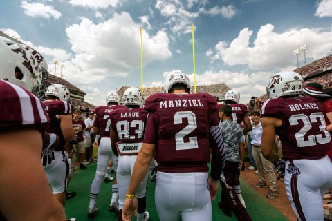 Texas A&M quarterback Johnny Manziel walks with his teammates onto the field for warm ups prior to an NCAA football game between the Texas A&M Aggies and the University of Alabama Crimson Tide.