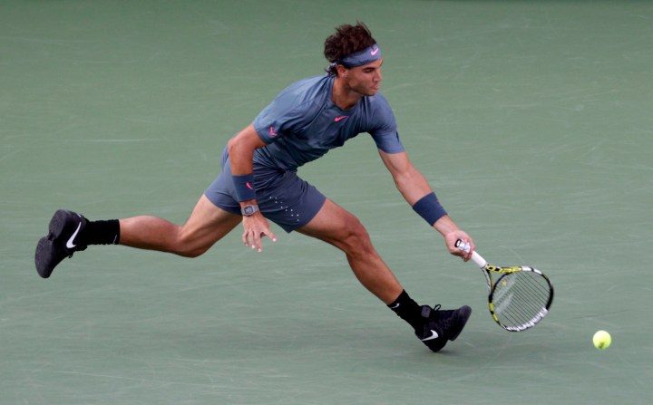 Nadal of Spain chases down a return to Djokovic of Serbia in their men's final match at the U.S. Open tennis championships in New York