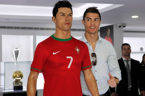 Cristiano Ronaldo poses with his statue during the inauguration of his museum in Funchal