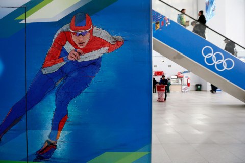 Visitors use an escalator in the Media Centre at the Olympic Park in Adler near Sochi