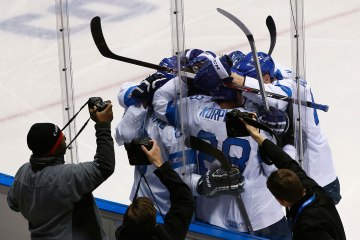 Photographers capture the celebration of Finland's Selanne and his linemates after he scored against Team USA during the second period of their men's ice hockey bronze medal game at the Sochi 2014 Winter Olympic Games