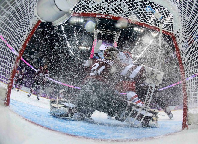 Latvia's goalie Edgars Masalskis makes a save against the Czech Republic during the first period of their men's preliminary round ice hockey game.