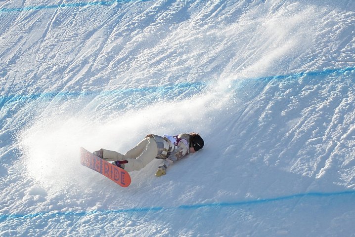 Jessika Jensen of the USA takes a fall during the ladies' snowboarding slopestyle qualifications at the Rosa Khutor Extreme Park at the Winter Olympics in Sochi, Russia, Feb. 6, 2014.