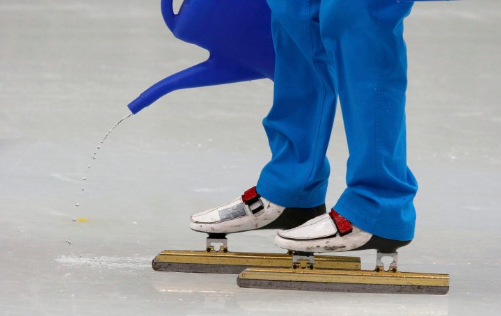 A blemish on the ice is repaired with the aid of a watering can during the women's 3,000 metres short track speed skating semi-finals relay race at the Iceberg Skating Palace during the 2014 Sochi Winter Olympics