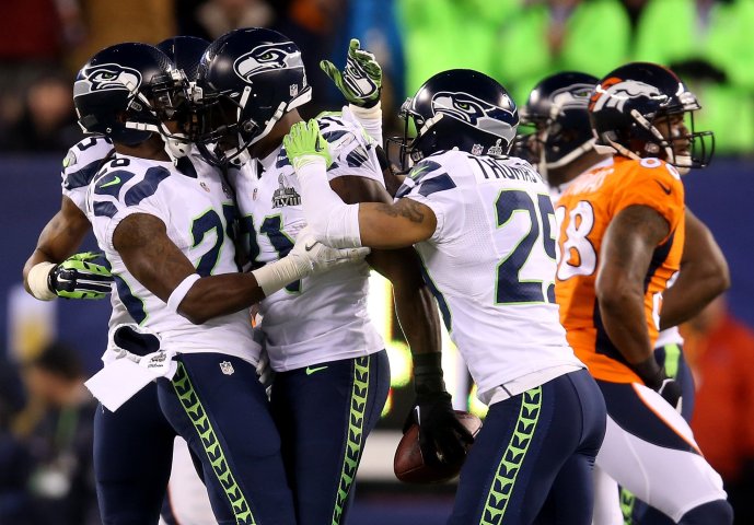 Strong safety Kam Chancellor of the Seattle Seahawks celebrates his interception with teammates against the Denver Broncos in the first quarter.