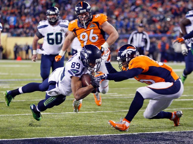 Seattle Seahawks wide receiver Baldwin dives into the end zone for a touchdown past Denver Broncos free safety  Adams during the fourth quarter in NFL Super Bowl XLVIII in East Rutherford