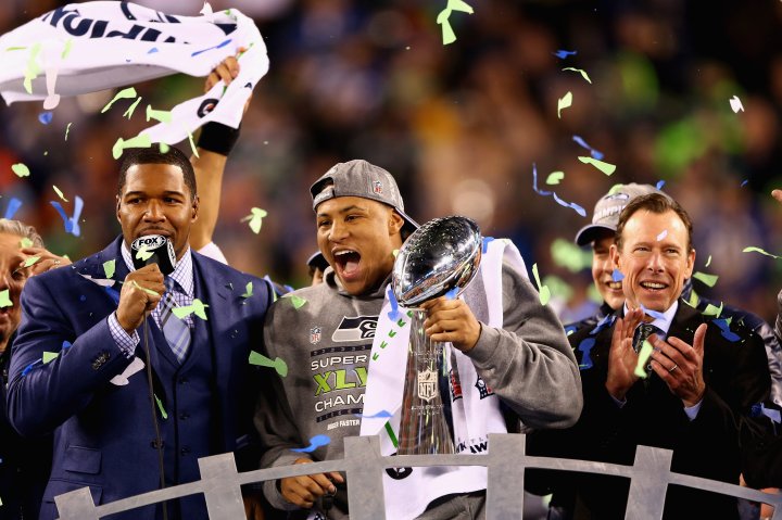 Outside linebacker and Super Bowl MVP Malcolm Smith of the Seattle Seahawks holds the Vince Lombardi Trophy after winning Super Bowl XLVIII.